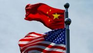 FILE PHOTO: Chinese and U.S. flags flutter near The Bund, before U.S. trade delegation meet their Chinese counterparts for talks in Shanghai, China July 30, 2019. REUTERS/Aly Song