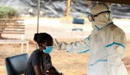 A woman has her temperature checked by a healthcare worker during a nationwide lockdown to help curb the spread of the coronavirus disease (COVID-19), at a mass screening and testing centre, in Harare, Zimbabwe April 30, 2020. REUTERS/Philimon Bulawayo