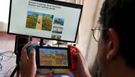 This photo taken on April 29, 2020 shows Australian high school teacher Dante Gabriele playing Nintendo's Animal Crossing at home in Melbourne during the country's enforced COVID-19 coronavirus lockdown. / AFP / William WEST /