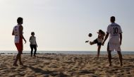 People play as they enjoy the sunny weather on the Barceloneta beach amidst the easing of restrictions implemented to curb the spread of the coronavirus disease (COVID-19), in Barcelona, Spain May 8, 2020. REUTERS/Nacho Doce