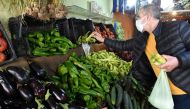 An Algerian man buys vegetables at a market on the outskirts of the capital Algiers, during the Muslim holy month of Ramadan, on April 25, 2020.  AFP / RYAD KRAMDI