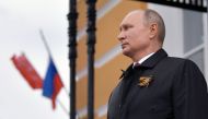 Russian President Vladimir Putin looks at military aircrafts flying over the Kremlin and Red Square to mark the 75th anniversary of the victory over Nazi Germany in World War Two, Moscow, May 9, 2020. / AFP / Alexey DRUZHININ
