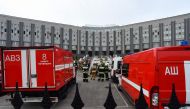 Emergencies personnel work at the site of a fire at the Saint George hospital in Saint Petersburg on May 12, 2020. A fire at a hospital in Russia's second city Saint Petersburg on May 12 killed five coronavirus patients who had been attached to ventilator