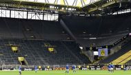 Schalke and Dortmund players play in an empty stadium during the German first division Bundesliga football match BVB Borussia Dortmund v Schalke 04 on May 16, 2020 in Dortmund, western Germany as the season resumed. AFP / POOL / Martin Meissner 