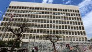 FILE PHOTO: A woman wearing a protective mask walks past Central Bank building as Lebanon extends a shutdown to curb the spread of the coronavirus disease (COVID-19) in Beirut, Lebanon, May 5, 2020. REUTERS/Aziz Taher