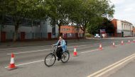 A cyclist is seen using a temporary cycling lane in Leicester, following the outbreak of the coronavirus disease (COVID-19), Leicester, Britain, May 17, 2020. REUTERS/Andrew Boyers
 