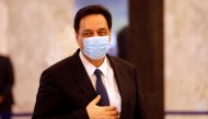 FILE PHOTO: Lebanon's Prime Minister Hassan Diab, wearing a mask, arrives to attend a meeting with Lebanese political leaders to present the plan aimed at steering the country out of a financial crisis, at the presidential palace in Baabda, Lebanon May 6,