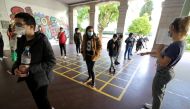 FILE PHOTO: Schoolchildren line up as they enter the primary school Simone Veil during its reopening in Nice as a small part of French children head back to their schools with new rules and social distancing during the outbreak of the coronavirus disease 