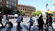People wearing face masks walk on a crosswalk, as some Spanish provinces are allowed to ease lockdown restrictions during phase one, amid the coronavirus disease (COVID-19) outbreak, in Valencia, Spain May 19, 2020. REUTERS/Nacho Doce
