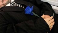 A blue rose is seen placed in the hands Jose Holguin, 50, originally from the Dominican Republic and who died of complications related to the coronavirus disease (COVID-19), during his viewing service at International Funeral & Cremation Services in the H