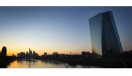 (FILES) This file photo taken on March 24, 2020 shows the sun setting behind the European Central Bank (ECB, R) and the city skyline in Frankfurt am Main, western Germany. / AFP / Daniel ROLAND