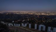 TOPSHOT - The Hollywood sign is pictured from the back at dusk during the second day of the Memorial Day holiday weekend, during the novel Coronavirus, COVID-19, pandemic in Los Angeles, California on May 24, 2020. / AFP / Apu GOMES

