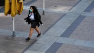 A woman wearing a protective face mask and gloves is seen in Canary Wharf, following the outbreak of the coronavirus disease (COVID-19), London, Britain, May 27, 2020. REUTERS/Dylan Martinez