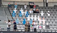Cardboard figures with pictures of the fans are placed in the seats as Ceres Park Football Stadium is being prepared for the Danish Superliga match between AGF and Randers FC to be streamed via the video platform Zoom, in Aarhus, Denmark May 27, 2020. Rit