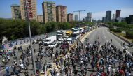 Nissan employees cut off one of the main entrances to Barcelona, as they protest against the closure of the Japanese cars manufacturer's plant in Barcelona on May 28, 2020.  AFP / LLUIS GENE