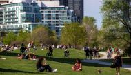 People maintain social distance as they sit at Humber Bay Shores park while the province prepares for more phased re-openings from the coronavirus disease (COVID-19) restrictions in Toronto, Ontario, Canada May 24, 2020. REUTERS/Carlos Osorio
