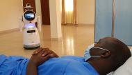 :A high-tech robot developed by Zora Bots, a Belgium-based company, and donated by the United Nations Development Program (UNDP) prepares to check the temperature of a health worker during a demonstration at the Kanyinya treatment centre that treats coron