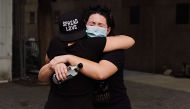 People embrace during the coronavirus pandemic on May 29, 2020 in New York City. Cindy Ord/Getty Images/AFP 