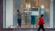 FILE PHOTO: An employee at Zara puts up a sign during a phased reopening from the coronavirus disease (COVID-19) restrictions in Toronto, Ontario, Canada May 19, 2020. REUTERS/Carlos Osorio/File Photo
