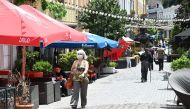 A woman wearing a protective face mask walks past a restaurant in Tbilisi on June 1, 2020, as Georgia lifts most of the restrictions on economic activity that were imposed as part of measures to contain the coronavirus spread. AFP / Vano Shlamov
