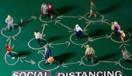 Small toy figures are placed on a chalkboard near 
