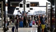 Commuters wearing protective face masks are seen at a platform at Milan central station, as Italy eases movement between regions as the country unwinds its rigid coronavirus disease (COVID-19) lockdown, in Milan, Italy June 3, 2020. REUTERS/Flavio Lo Scal