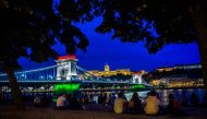 The Chain Bridge is illuminated in the colours of the Hungarian national flag in Budapest on June 4, 2020, as an event to commemorate the 100th anniversary of the Trianon WWI peace agreement. / AFP / FERENC ISZA