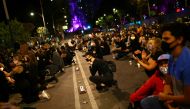 A woman kneels as she participates in a demonstration against the death in Minneapolis police custody of George Floyd, in front of the U.S embassy in Mexico City, Mexico June 4, 2020. REUTERS/Edgard Garrido
