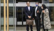 Iranian doctor Majid Taheri (L), who had been detained in the United States for 16 months, is welcomed by his wife and an Iranian Foreign Ministry official upon his arrival at Tehran's Imam Khomeini International Airport on June 8, 2020. AFP / MEHR NEWS /