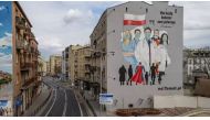 FILE PHOTO: A mural showing medical personel wearing protective masks is seen painted on a wall of a building following the coronavirus disease (COVID-19) outbreak in Warsaw, Poland, April 1, 2020. Slawomir Kaminski/Agencja Gazeta via REUTERS

