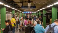 NEW YORK, NY - JUNE 08: People wait for the train at Times Square during rush hour on the first day of phase one of the reopening after the coronavirus lockdown on June 8, 2020 in New York City. New York City enters phase one one hundred days after the fi