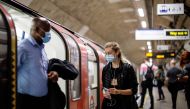Commuters wearing a face mask travel on TfL Victoria Line underground train carriages, heading towards central London, on June 15, 2020 after new rules make wearing face coverings on public transport compulsory while the UK further eases its coronavirus l