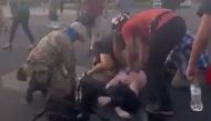 Attendees help a man who was shot and wounded during clashes between protesters trying to pull down a statue of Juan de Onate and armed members of civilian militia group New Mexico Civil Guard in downtown Albuquerque, New Mexico, U.S. June 15, 2020, in th