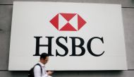 A man walks past a logo of HSBC at its headquarters in Kuala Lumpur, Malaysia August 6, 2019. REUTERS/Lim Huey Teng/File Photo