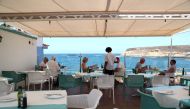 FILE PHOTO: Waiter Yamilca from Cuba attends tourists in a terrace of an almost empty restaurant 