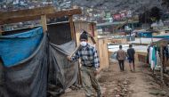 A man carrying a pick walks at the Cantagallo community, where some 300 families of the Shipibo Conibo ethnic group inhabit, in Lima on June 18, 2020. AFP / ERNESTO BENAVIDES
