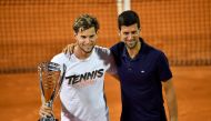 (FILES) In this file photo taken on June 14, 2020 Austrian tennis player Dominic Thiem poses for a photo with Serbian tennis player Novak Djokovic after winning the final match against Serbian tennis player Filip Krajinovic at the Adria Tour, Novak Djokov