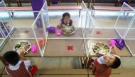 Kindergarten students from the Wichuthit school eat their lunch during a rehearsal social distancing and measures to prevent the spread of the coronavirus disease (COVID-19) ahead of nationwide schools reopening in Bangkok, Thailand, June 23, 2020. REUTER