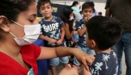 FILE PHOTO: A child receives a vaccination as part of the start of the seasonal flu vaccination campaign as a preventive measure due to the outbreak of coronavirus disease (COVID-19), in Santiago, Chile March 16, 2020. REUTERS/Ivan Alvarado/File Photo