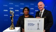 FIFA Secretary General Fatma Samoura (L) and FIFA President Gianni Infantino pose next to the Women's World Cup Trophy after the announcement that Australia/New-Zealand are the winning hosts for the FIFA Women's World Cup 2023 (FWWV23) during a virtual FI