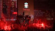 Fans celebrate Liverpool winning the Premier League title outside Anfield stadium in Liverpool, north west England on June 25, 2020, following Chelsea's 2-1 victory over Manchester City. AFP / Oli SCARFF