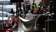 A forensic officer works at the scene of reported multiple stabbings at West George Street in Glasgow, Scotland, Britain June 26, 2020. REUTERS/Russell Cheyne
