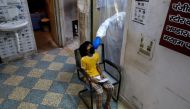 A health worker in personal protective equipment (PPE) collects a sample using a swab from a girl at a local health centre to conduct tests for the coronavirus disease (COVID-19), amid the spread of the disease, in New Delhi, India June 27, 2020. REUTERS/
