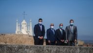 Portuguese President Marcelo Rebelo de Sousa (2R), Spain´s King Felipe VI (R), Portuguese Prime Minister Antonio Costa (2L) and Spanish Prime Minister Pedro Sanchez (L) wear face masks and wave during a ceremony for the reopening of the border between Spa