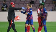 An Atletico Madrid staff member greets Barcelona's French forward Antoine Griezmann (C) at the end of the Spanish League football match between FC Barcelona and Club Atletico de Madrid at the Camp Nou stadium in Barcelona on June 30, 2020. / AFP / LLUIS G