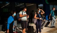 Passengers of a flight from Budapest wearing protective face masks arrive at the Corfu Airport Ioannis Kapodistrias on Corfu Island on July 1, 2020, on its reopening day following months of closure due to the sanitary measures taken to curb the spread of 