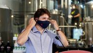 FILE PHOTO: Canada's Prime Minister Justin Trudeau removes his face mask as he visits the Big Rig Brewery, which utilizes the Canada Emergency Wage Subsidy given to businesses affected by the coronavirus disease (COVID-19) outbreak, in Kanata, Ontario, Ca