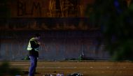 Washington State Patrol investigator inspects the scene where two people in a group of protesters were struck by a car on Interstate 5 while the highway was closed to traffic due to the protest in Seattle, Washington, U.S. REUTERS/Jason Redmond