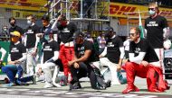 Formula One F1 - Austrian Grand Prix - Red Bull Ring, Spielberg, Styria, Austria - July 5, 2020 Mercedes' Lewis Hamilton, Ferrari's Sebastian Vettel and the rest of the drivers kneel on the grid wearing an anti-racism T-shirt before the race Mark Thompson