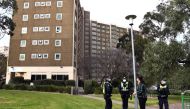 Police stand guard at one of nine public housing estates locked down due to a spike in COVID-19 coronavirus numbers in Melbourne on July 6, 2020. AFP / William WEST